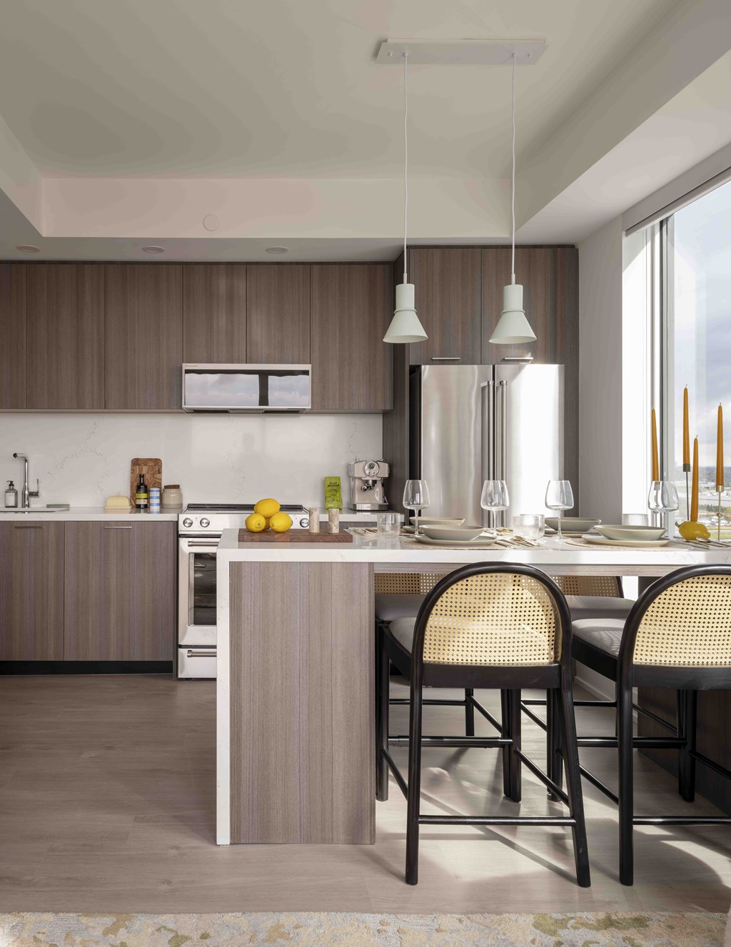 A modern kitchen with a dining table and chairs.