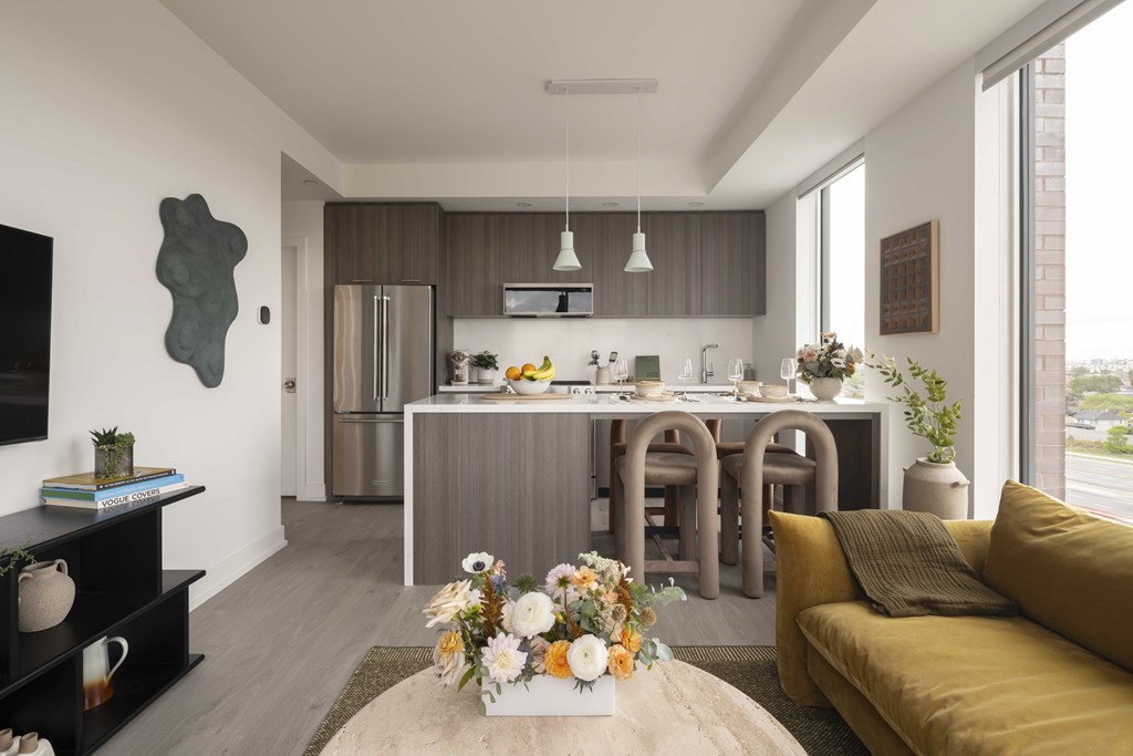 A modern kitchen with a dining table and chairs.