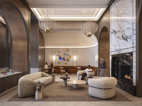 A modern living room with a fireplace and a painting on the wall.