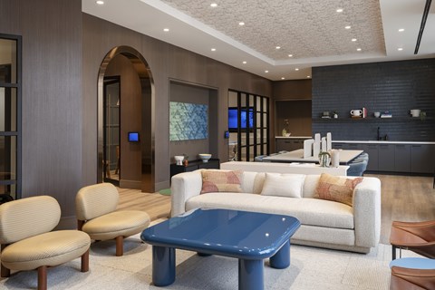 A modern living room with a blue coffee table and a white sofa.