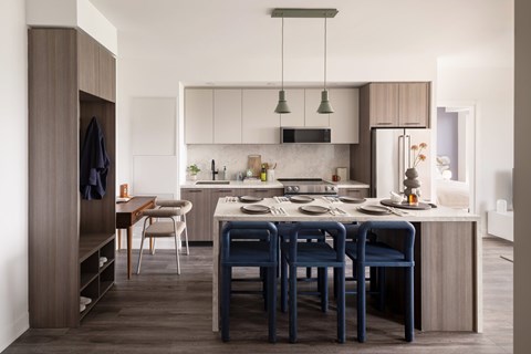 A modern kitchen with a dining table and chairs.