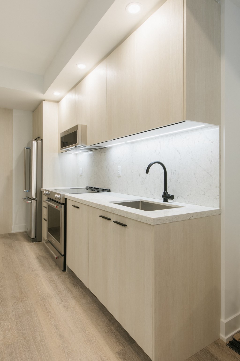 a kitchen with white cabinets and a sink