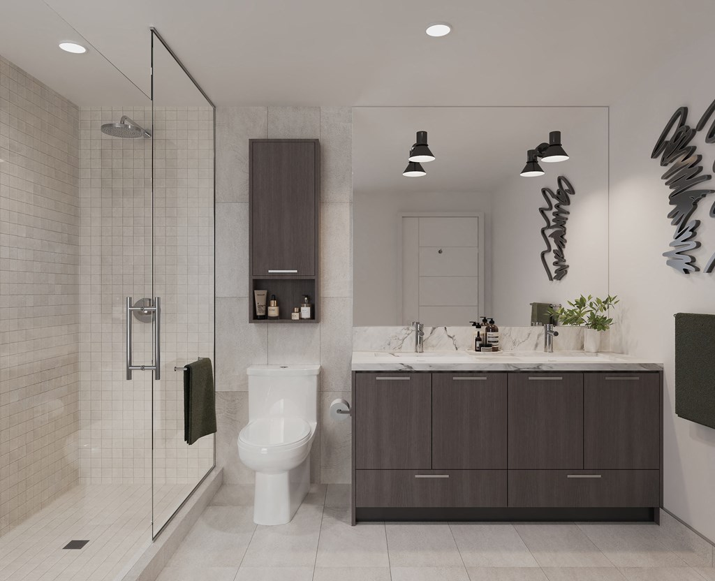 a bathroom with a toilet and a sink and a shower