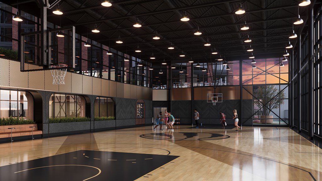 A basketball court with players practicing.