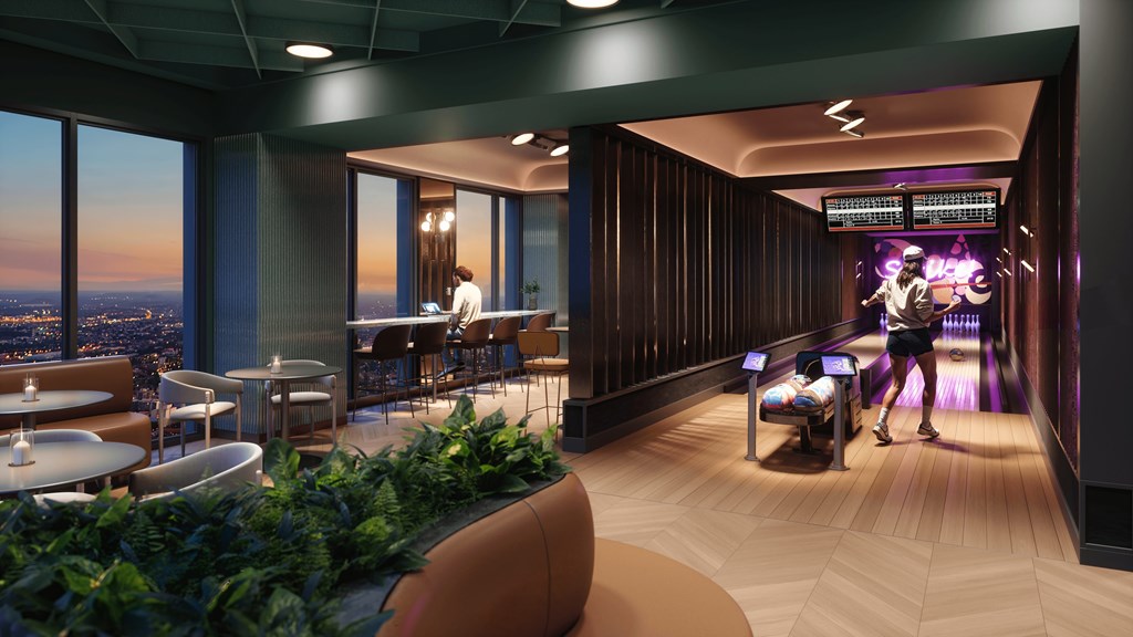 A modern lounge area with a view of the city at dusk.