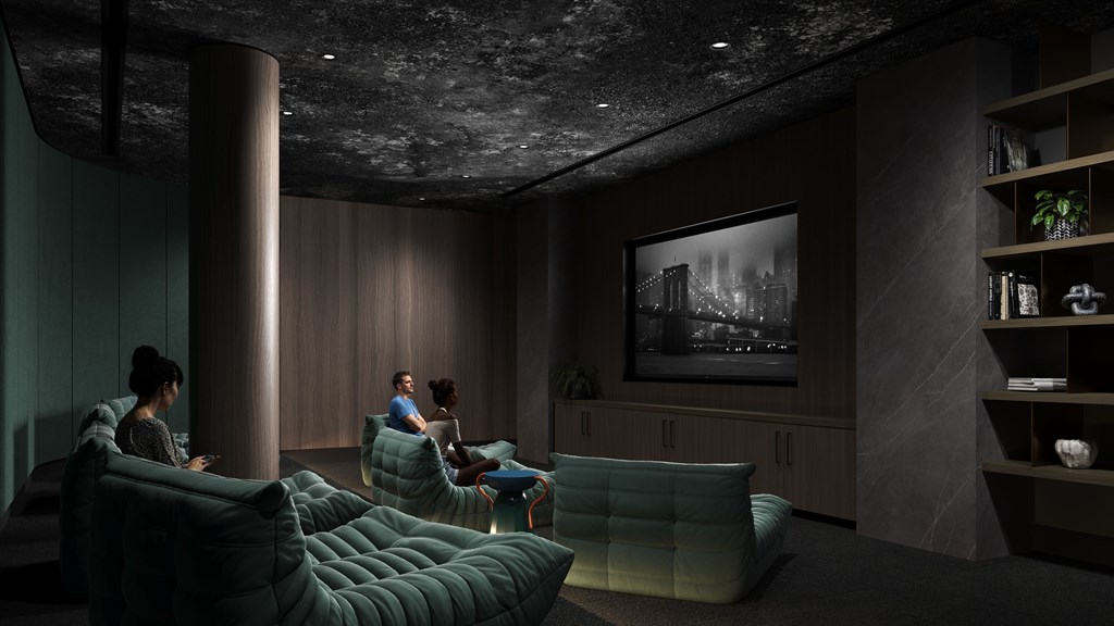 Two people sitting on a couch in a room with a large picture on the wall.