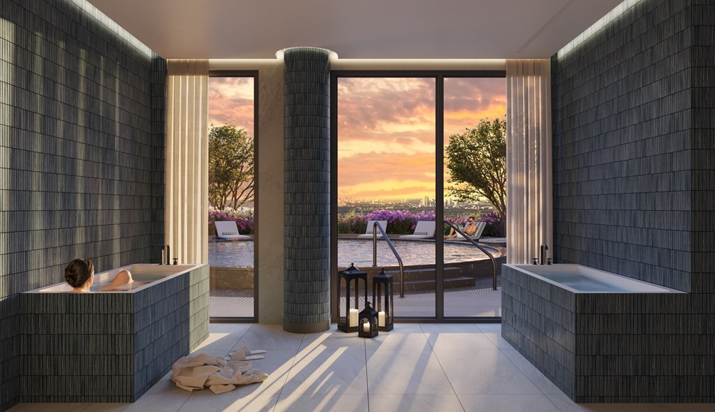 A modern bathroom with a large window overlooking a pool and trees.
