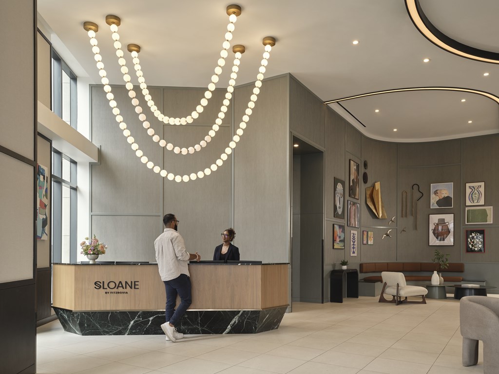 A reception area with a receptionist and a guest.