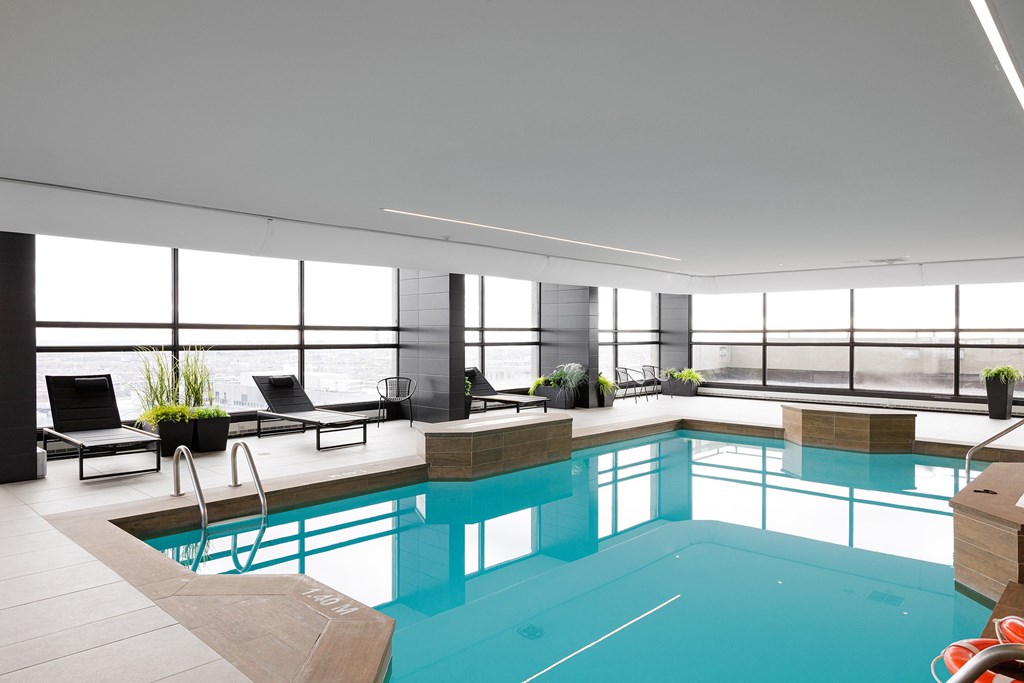 A large indoor swimming pool with a sunken seating area.