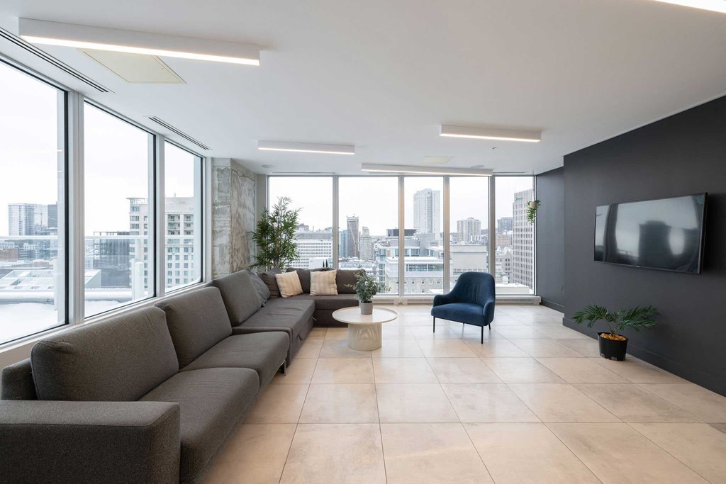 a living room with a large window and a couch and a table