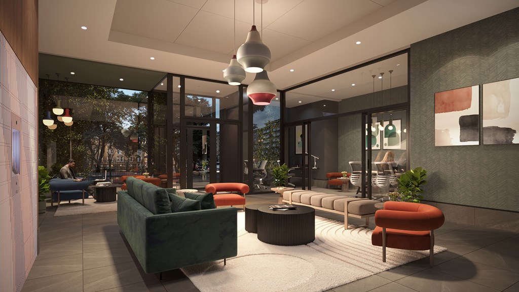 A modern living room with a green couch and a red chair.