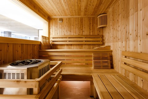 a sauna with wooden walls and a table