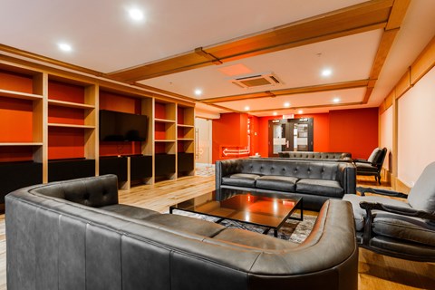 a living room with leather couches and a coffee table