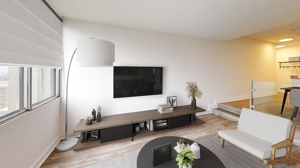 A modern living room with a white sofa and a black coffee table.