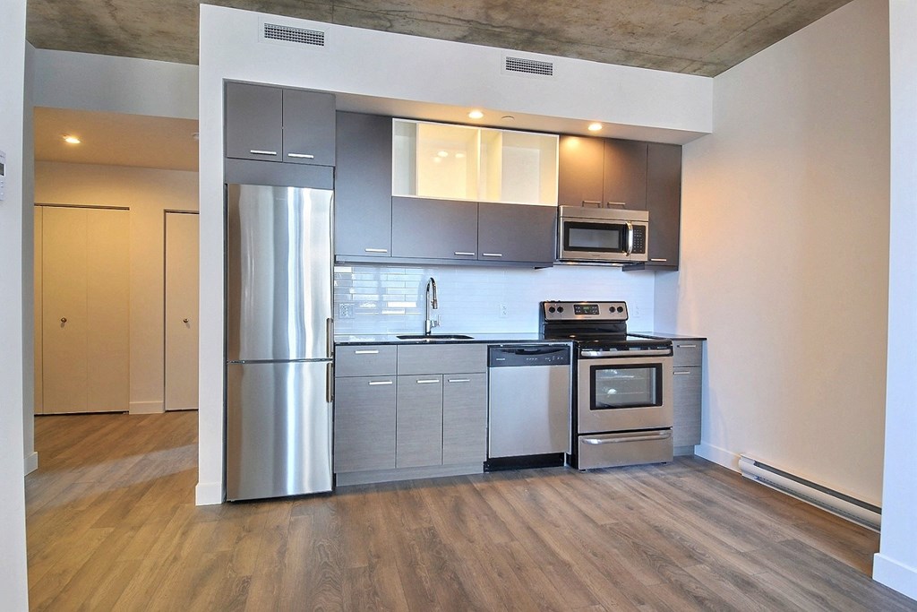 a kitchen with stainless steel appliances and a refrigerator