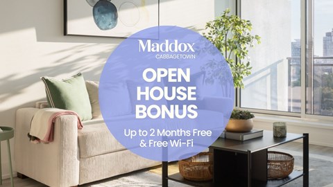 A living room with a couch and a sign that says "Maddox CABBAGETOWN OPEN HOUSE BONUS Up to 2 Months Free & Free Wi-Fi".