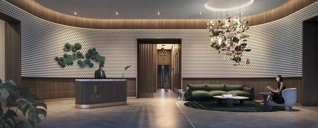 a lobby with a green couch and a chandelier