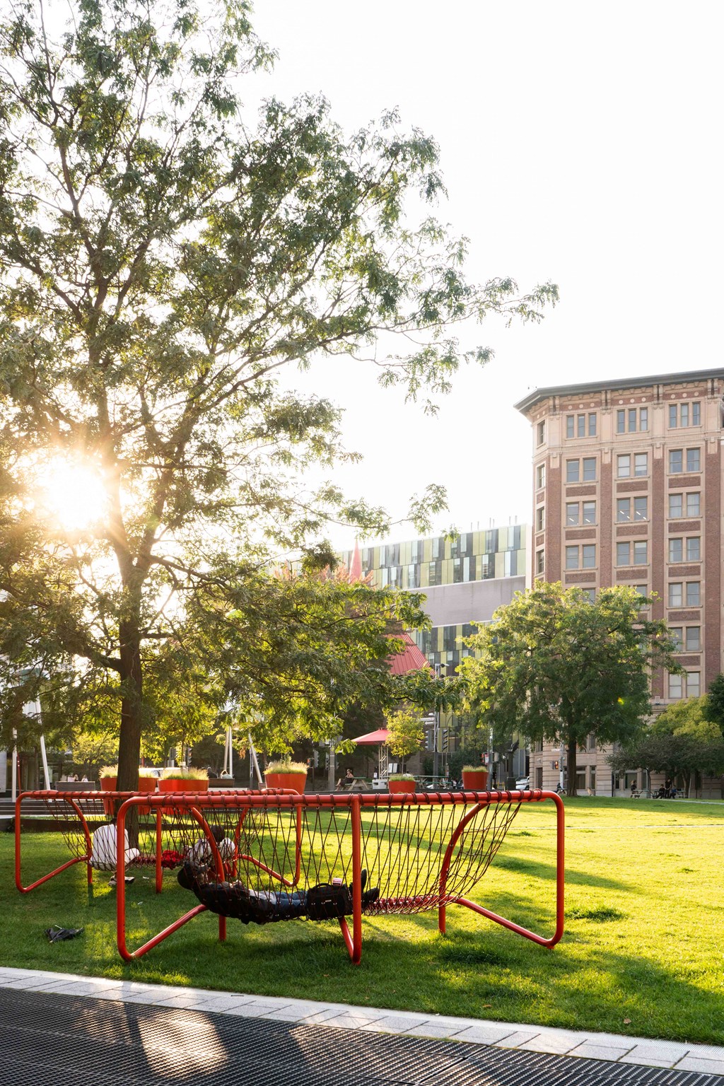 a person laying on a swing in a park