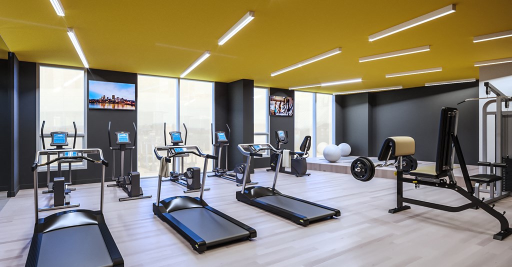 a fitness room with treadmills and other exercise equipment