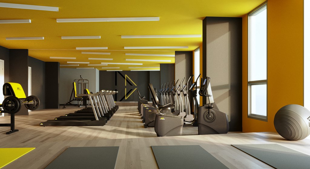 a row of exercise equipment in a gym with a yellow ceiling