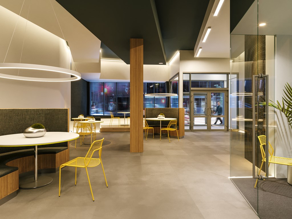 a rendering of a lobby with yellow chairs and tables