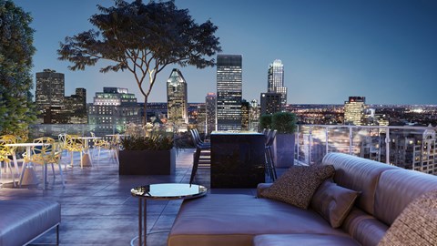 a view of the city skyline from a rooftop terrace with a couch