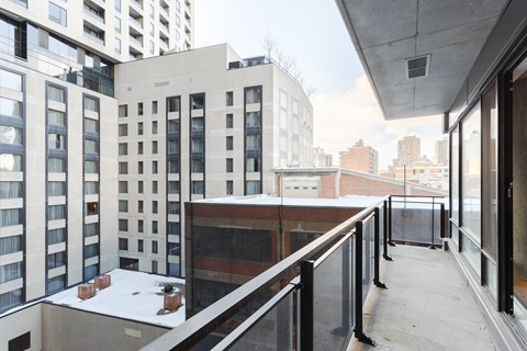 a balcony with a view of the city in the distance