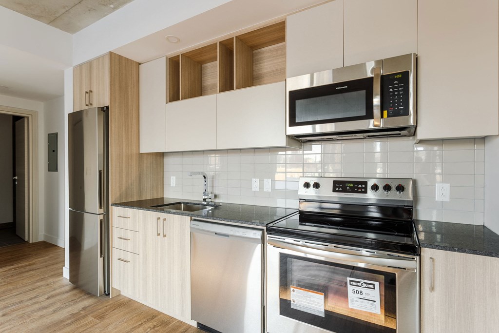 a kitchen with stainless steel appliances and white cabinets