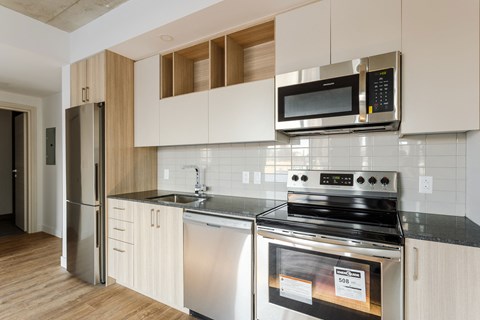 a kitchen with stainless steel appliances and white cabinets