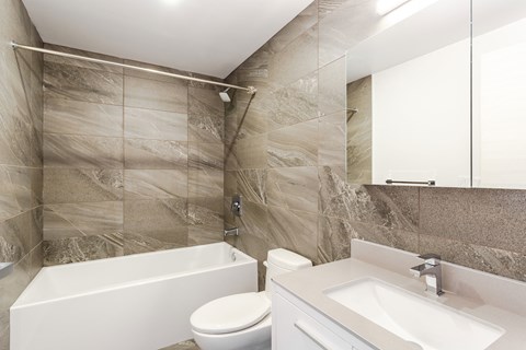 a bathroom with a sink toilet and a bath tub