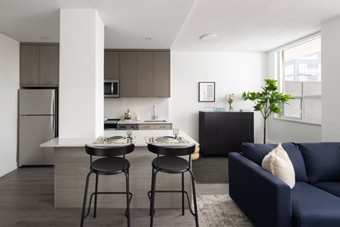A modern kitchen with a dining table and chairs.
