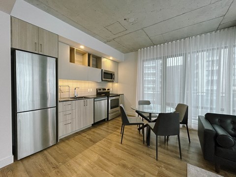 a kitchen and dining room with a table and chairs