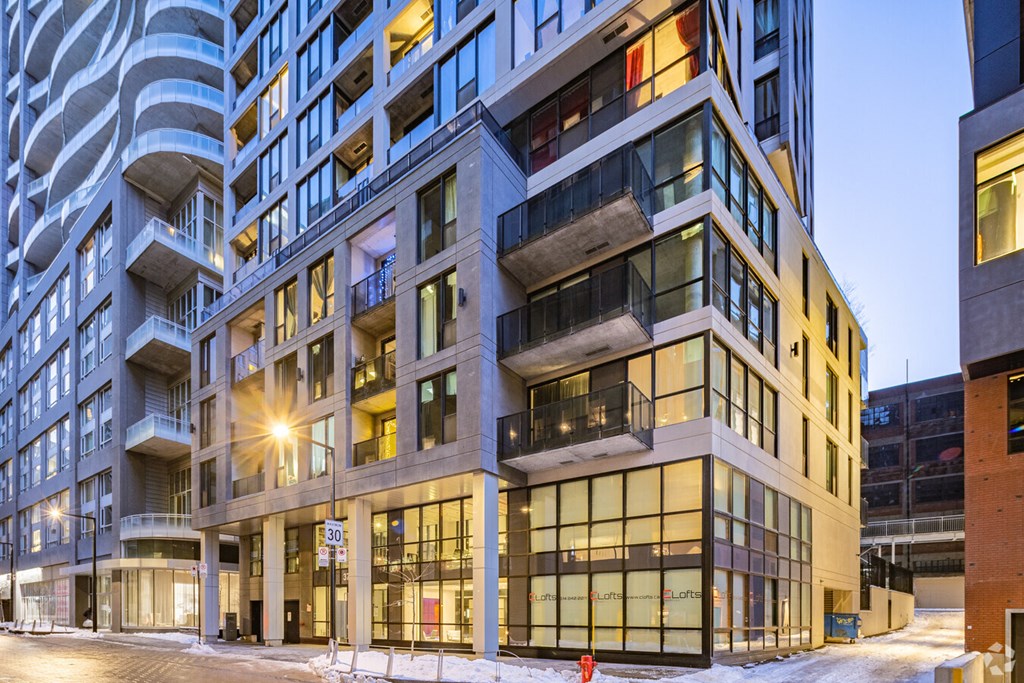 a view of a building on a city street at dusk