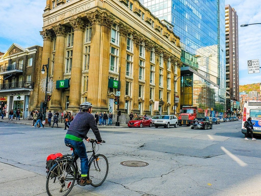 a man riding a bike down a city street
