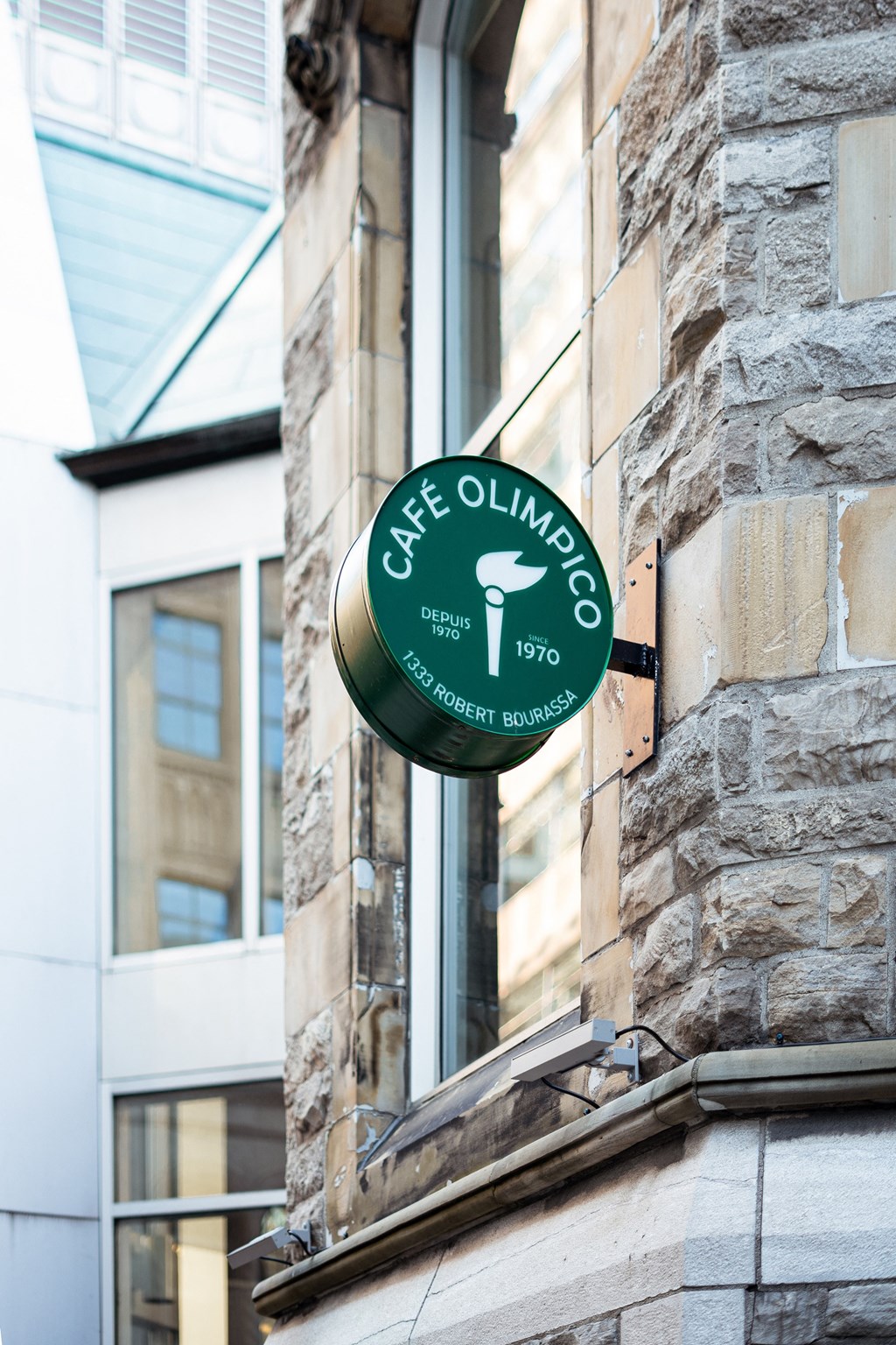 a green sign on the side of a brick building