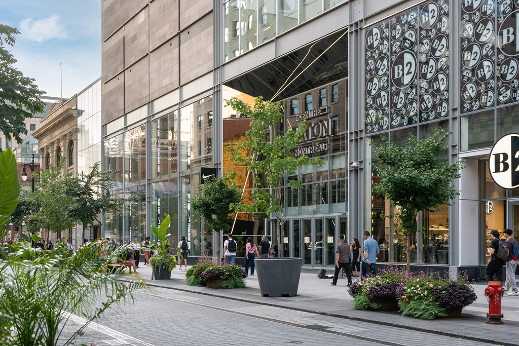 people walking in front of a glass building
