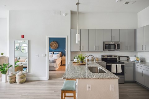 A kitchen with a counter and a chair.