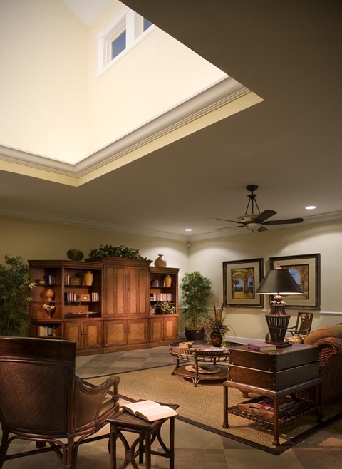 a living room filled with furniture and a ceiling light