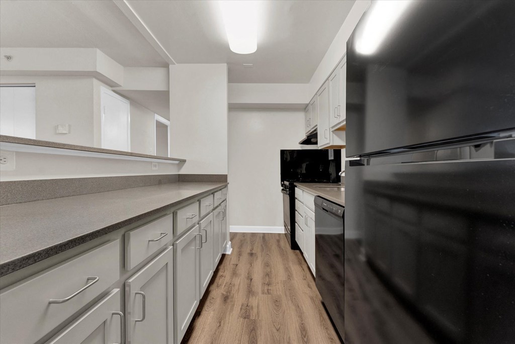 Kitchen With White Cabinetry And Black Appliances at Autumn Woods, Bladensburg, MD, 20710