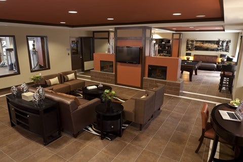 a large living room with couches and a television