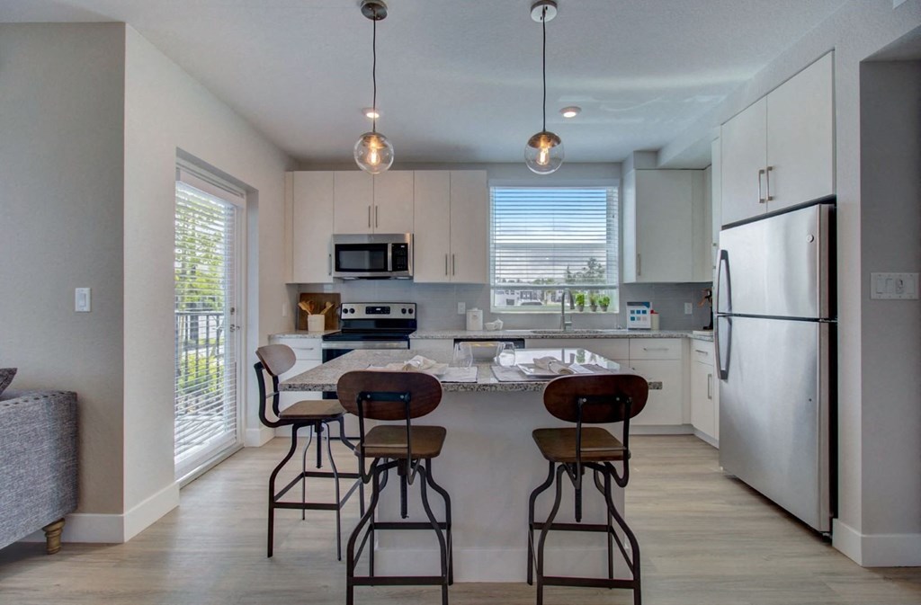 Kitchen with designer finishes at Everly Apartments in Naples, FL
