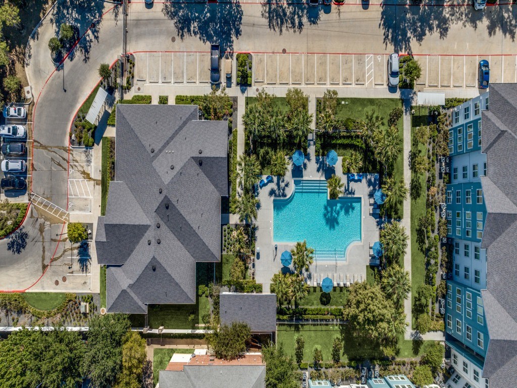 A bird's eye view of a residential area with a swimming pool and a playground.