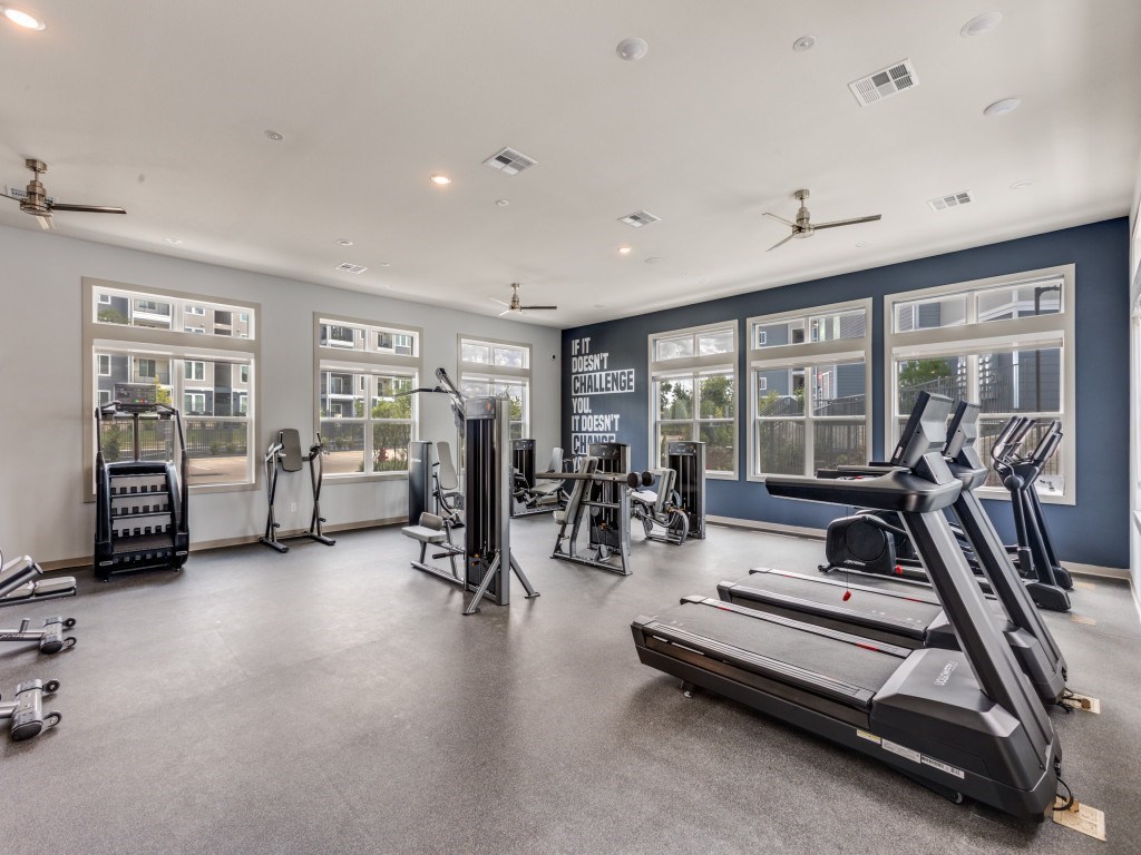 A spacious gym with a variety of equipment including treadmills, weights, and exercise machines.