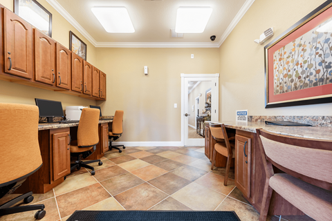 A kitchen with brown cabinets and tile flooring.