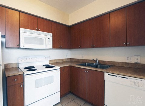 a kitchen with a stove microwave and sink