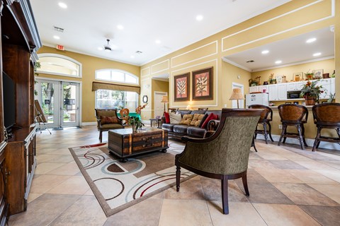 A living room with a brown chair and a brown couch.