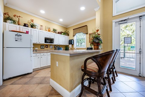 A kitchen with a white refrigerator and a white counter top.