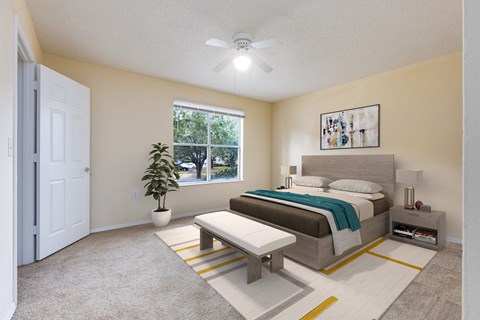 a bedroom with a bed and a ceiling fan
