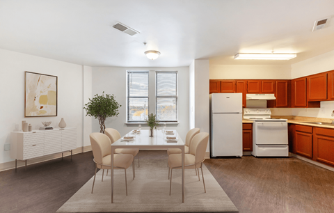 A modern kitchen with a dining table and chairs.