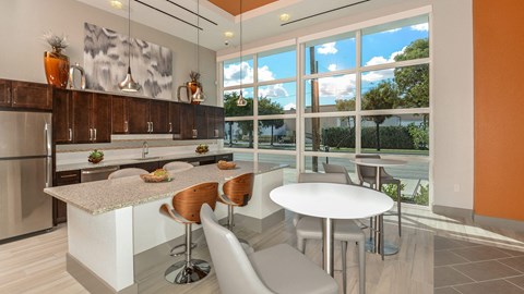 a kitchen with a large window and a table with chairs